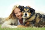 Smiling Woman Hugging German Shepherd Dog